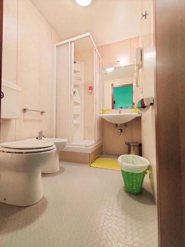 a bathroom with a toilet and a sink at Hotel Serenella in Turin