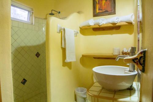 a bathroom with a toilet and a sink and a shower at Bungalows Jaqueline in Sayulita