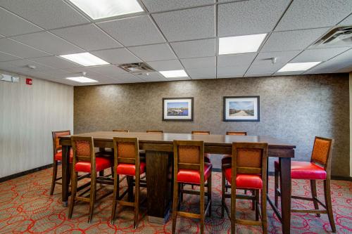 a conference room with a long table and chairs at Inn at Hunters Run in Watford City
