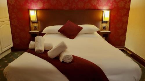 a bedroom with a large white bed with towels on it at The Pelican Inn in Stapleford