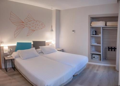
a bedroom with a bed and a desk at Hotel Mediterraneo Valencia in Valencia
