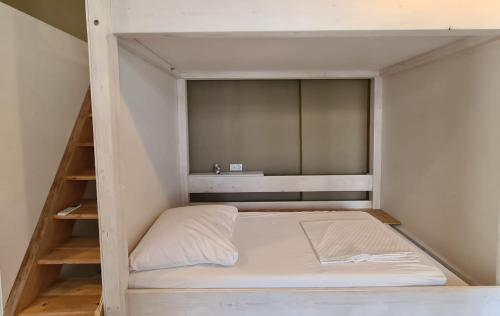 a bunk bed in a small room with a ladder at Jetpak Alternative Eco Hostel in Thessaloniki