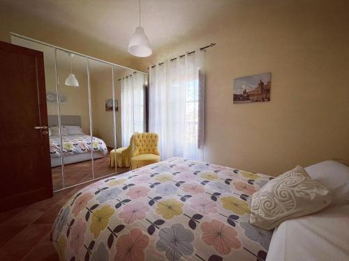 a bedroom with a bed with a flower patterned comforter at Kasa Kala Rooms & Apartments in Palermo