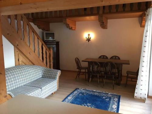 a living room with a couch and a table with chairs at Gundhabing flat in Kitzbühel