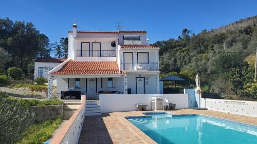 a house with a swimming pool in front of it at Casa Baptista in Monchique
