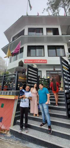 a group of people standing on steps in front of a building at Casa Arhan 2-3-4-7-12 BHK Luxury Penthouse in Mussoorie