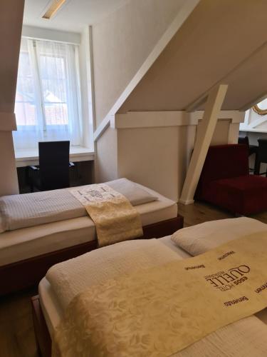 a room with three beds and a staircase at Esos Hotel Quelle in Bad Ragaz