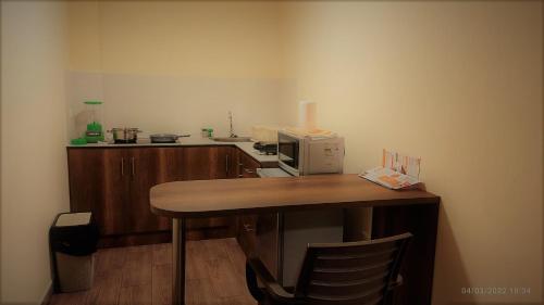 a kitchen with a table with a microwave on it at Apart Cayambe in Cayambe