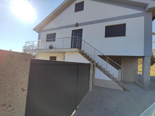 a white house with a staircase in front of it at Casa Corredoura in Ponte de Lima