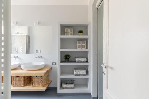 a bathroom with two sinks and a mirror at iFlat Saint Peter Bright Apartment in Rome