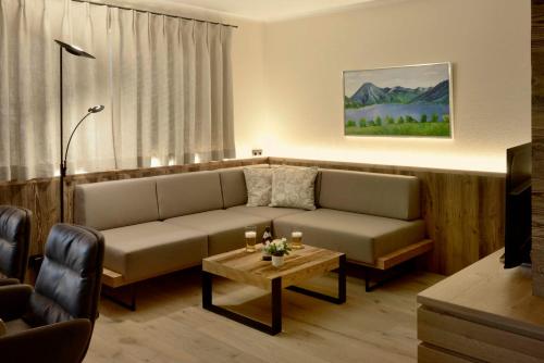 a living room with a couch and a table at Lake Life 9 in Bad Wiessee