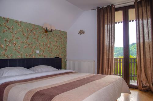 Säng eller sängar i ett rum på Bucovina Residence & SPA