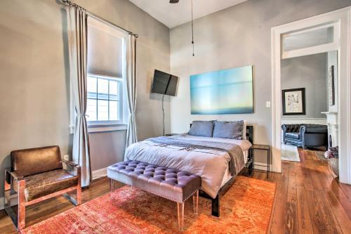 a bedroom with a bed and a chair at Uptown NOLA Apt on Magazine Street with Backyard! in New Orleans