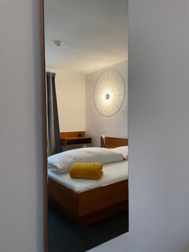 a reflection of a bedroom with a bed in a mirror at Hotel Jägerhof in Coesfeld