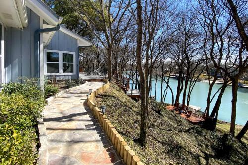 a walkway next to a house next to a lake at 10 Mi to New Braunfels Waterfront Seguin Gem in Seguin