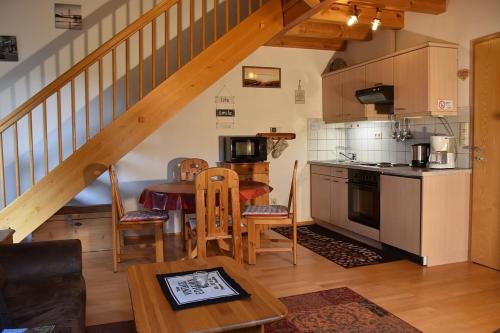 a kitchen with a table and a dining room at Ferienhaus Nr 10B2, Feriendorf Hagbügerl, Bayr Wald in Waldmünchen