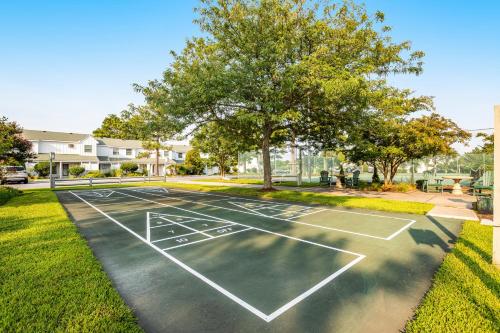 a tennis court in a yard with a tree at Mallard Lakes -- 158 Cardinal in Fenwick Island