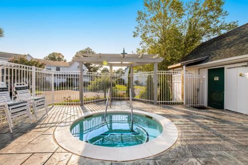 a hot tub with a swing in a yard at Mallard Lakes -- 158 Cardinal in Fenwick Island