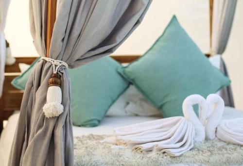 a bed with two white swans on it with pillows at The Bubble Valley Piet Retief in Piet Retief
