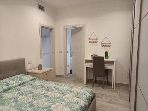 a bedroom with a desk and a bed and a table at Titina's House in Tertenìa