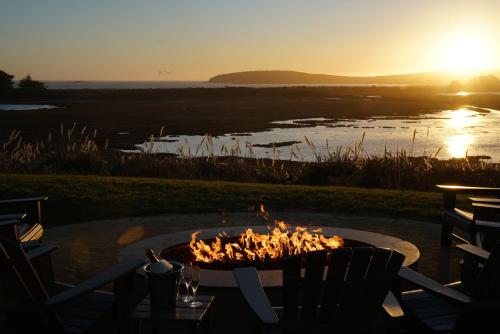 a fire pit with the sunset in the background at The Lodge at Bodega Bay in Bodega Bay