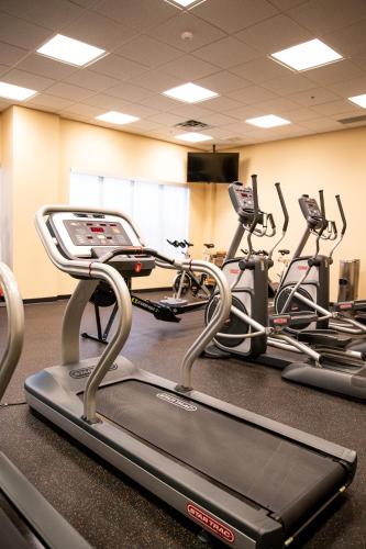 a gym with three cardio bikes in a room at Hotel 11, MOD A Sonesta Collection in Calgary