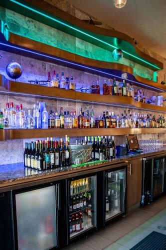 a bar with lots of bottles of alcohol at Hotel 11, MOD A Sonesta Collection in Calgary