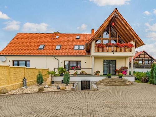 a large house with an orange roof at Apartment with balcony in Harz Mountains in Cattenstedt