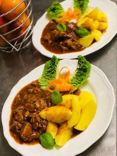 two white plates of food on a table at Gasthaus Dernedde in Osterode