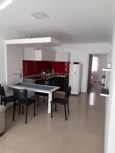 a kitchen with a table and chairs and a refrigerator at España 132 in Villa Regina