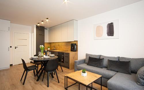 a living room with a couch and a table at Apartament Nakielska 46a lux 40m2 in Bydgoszcz