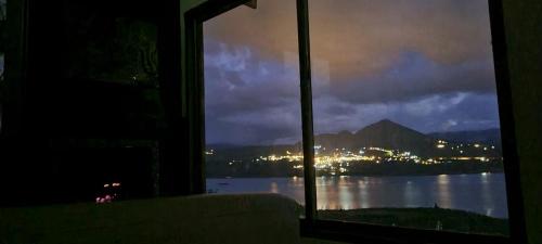 a room with a window looking out at the water at Villa Vista in Guatavita