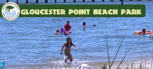 a group of people in the water at a beach at Holiday Inn Express - Gloucester by IHG in Gloucester
