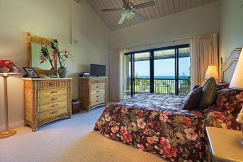 a bedroom with a bed and a view of the ocean at Hanalei Bay Resort 7302 in Princeville