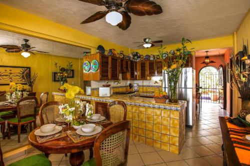 a kitchen with a table and a dining room at El Dorado 404 in Puerto Vallarta