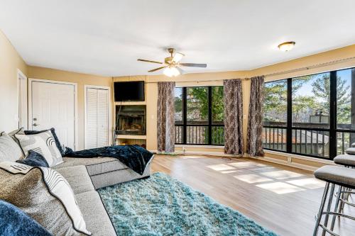 a living room with a couch and a large window at Respite Ridge in Banner Elk