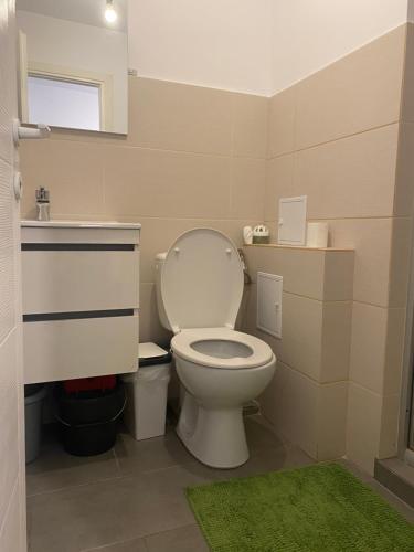 a bathroom with a white toilet and a sink at Sweet Appartament in Timişoara