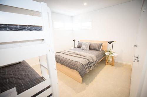 a bedroom with a bed and a bunk bed at Lefties @ The Bay, Gracetown, Margaret River - NEW in Gracetown