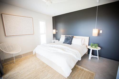 a bedroom with a large bed and two tables at Lefties @ The Bay, Gracetown, Margaret River - NEW in Gracetown