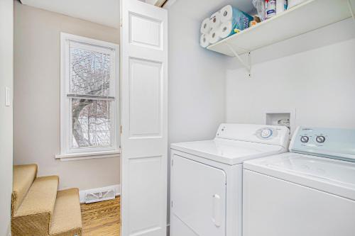 une buanderie avec un lave-linge et un sèche-linge ainsi qu'une fenêtre dans l'établissement Anchors Away, à New Buffalo
