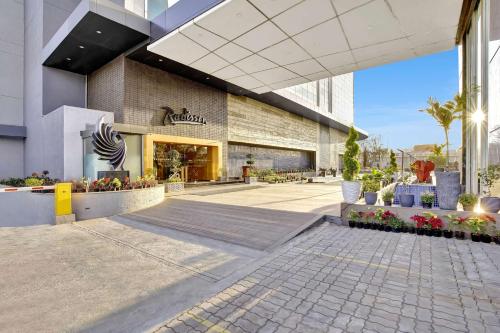 a store front of a building with plants and flowers at Radisson Hotel Nathdwara in Nāthdwāra