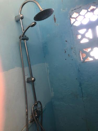 a shower with a shower head in a bathroom at kolay chambre HOTE in Saint-Pierre