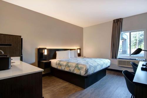 a hotel room with a bed and a window at Studio 6 Pensacola, FL - West I-10 in Pensacola