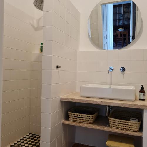 a bathroom with a sink and a mirror at Casa Magana em Grândola in Grândola