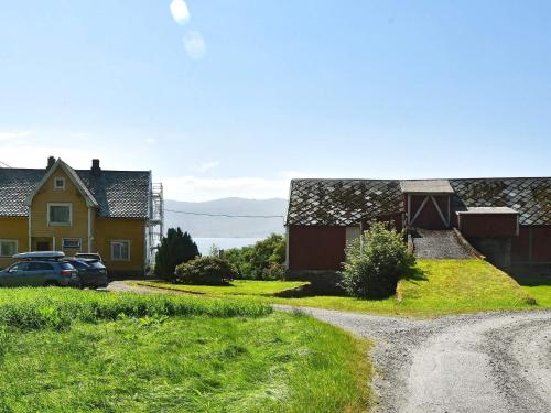 a dirt road in a village with houses and a car at 6 person holiday home in FISK in Fiskå