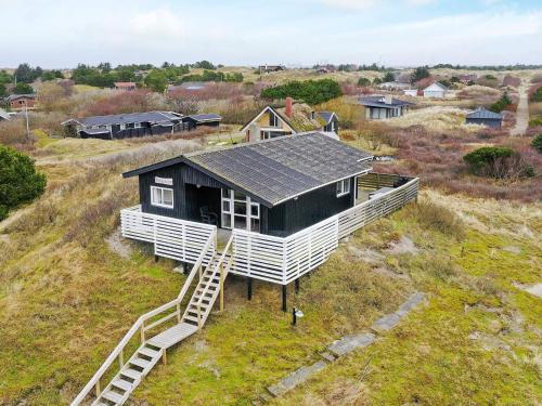 a house with a solar roof on top of a field at Holiday home Fanø CCIII in Fanø