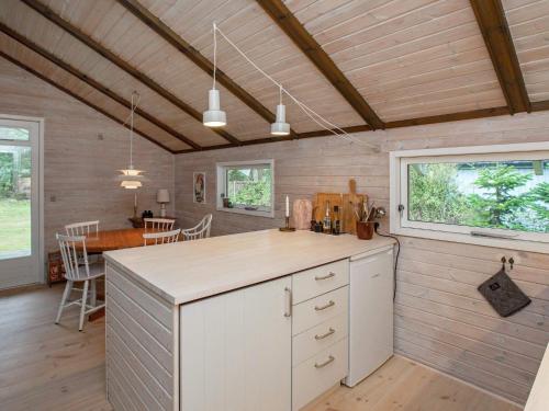 een keuken met een aanrecht en een eetkamer bij 4 person holiday home in V ggerl se in Bøtø By
