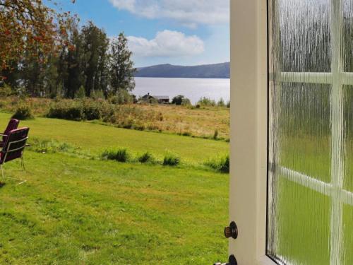 a door with a window with a view of the water at 6 person holiday home in STRA NTERVIK in Östra Ämtervik