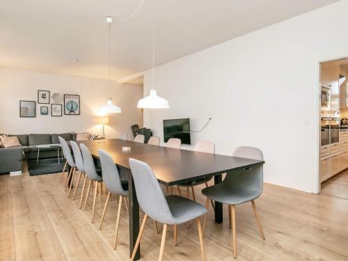 een eetkamer met een tafel en stoelen bij 16 person holiday home in Rudk bing in Rudkøbing