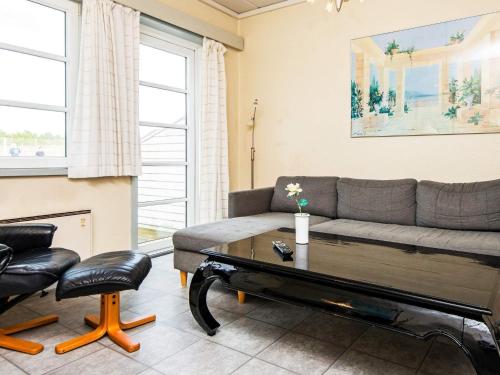 a living room with a couch and a coffee table at 4 person holiday home in Rømø-By Traum in Sønderby
